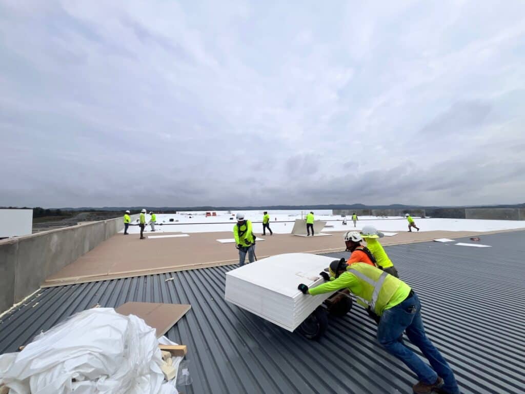 Commercial roofers on a roof